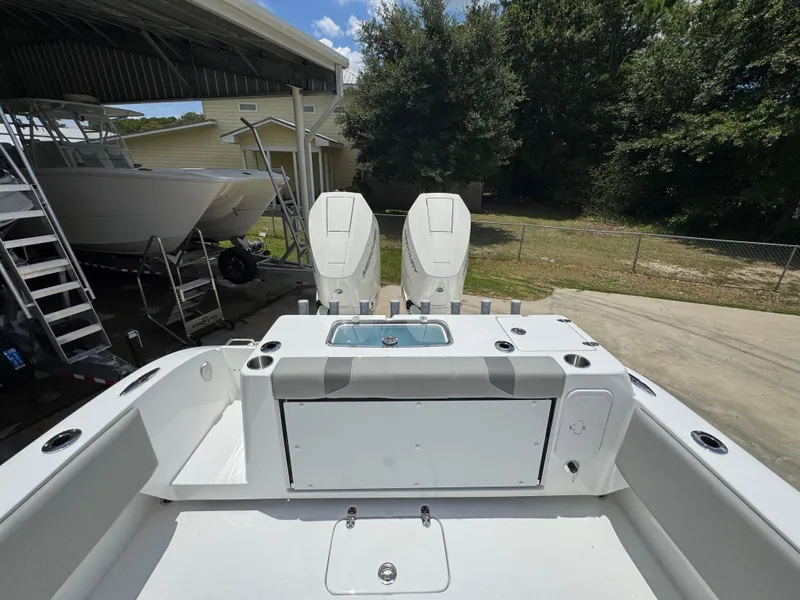 Slide: The Image of 2026 Cape Horn 34 XS boat with dual outboard engines, docked under a canopy. - 39