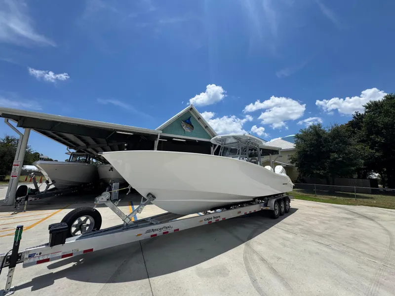 Slide: The Image of 2026 Cape Horn 34 XS boat on trailer under clear blue sky. - 4