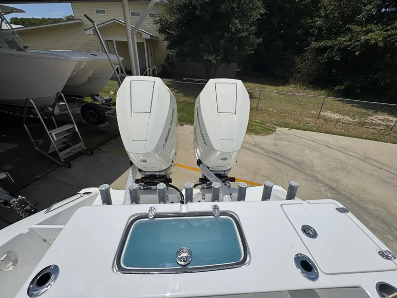 Slide: The Image of 2026 Cape Horn 34 XS boat with dual Mercury outboard engines, docked outdoors. - 40
