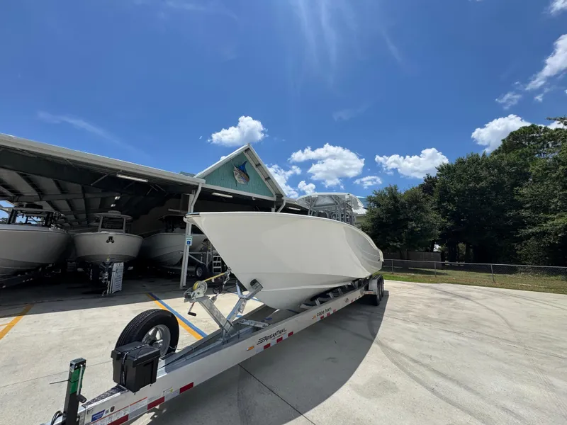 Slide: The Image of 2026 Cape Horn 34 XS boat on trailer under clear blue sky. - 5