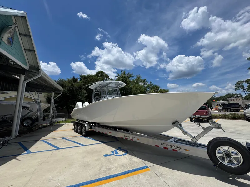 Slide: The Image of 2026 Cape Horn 34 XS boat on trailer under blue sky with clouds. - 9