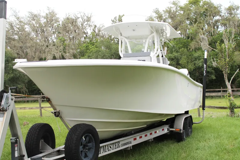 The Image of 2005 Yellowfin 31 Center Console boat on calm water with cityscape background. - 0