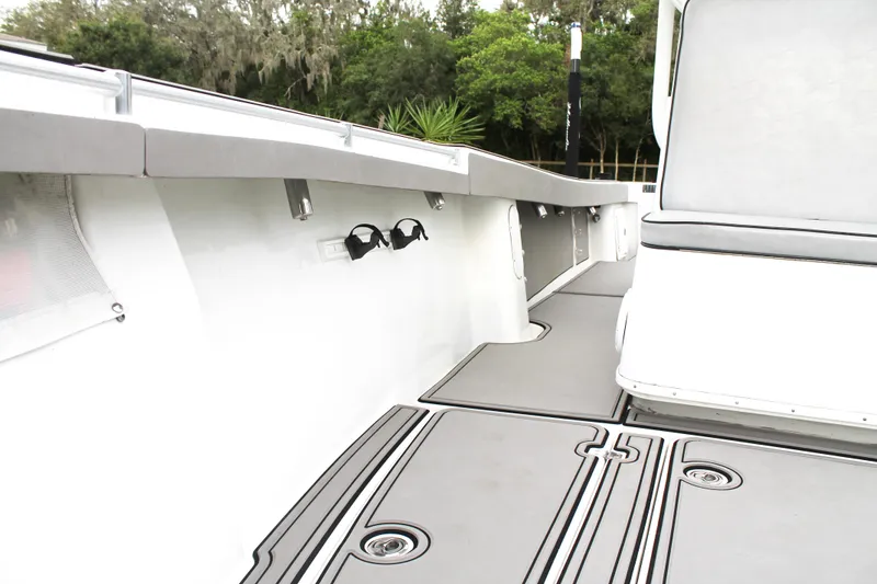 Slide: The Image of 2005 Yellowfin 31 Open boat on trailer with dual outboard engines, parked on grass. - 12