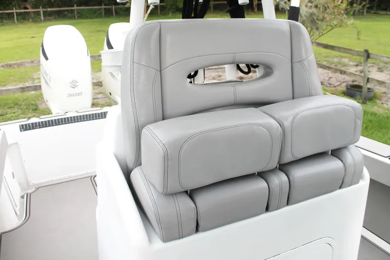 Slide: The Image of 2005 Yellowfin 31 Open boat with T-top and rod holders, set in a lush green background. - 16