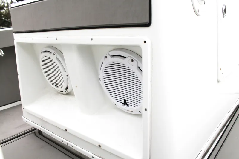 Slide: The Image of 2005 Yellowfin 31 Open boat interior with gray seating and dual Suzuki engines. - 23