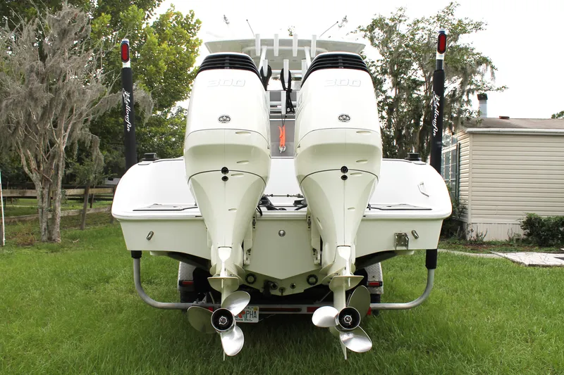 Slide: The Image of 2005 Yellowfin 31 Center Console boat on calm water near a bridge. - 3