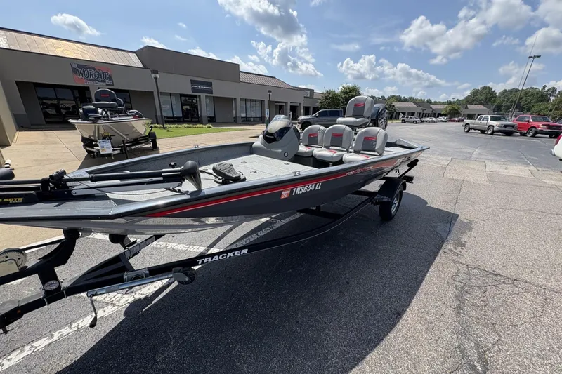 Slide: The Image of 2016 Tracker Pro Team 175 TF boat on trailer, parked outside dealership under sunny sky. - 3