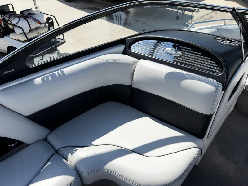 Slide: The Image of 2006 Malibu 23 VLX boat interior with white and black seating, sleek design. - 10