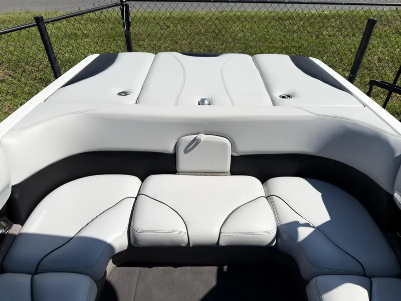 Slide: The Image of 2006 Malibu 23 VLX boat interior with white cushioned seating and sleek design. - 19