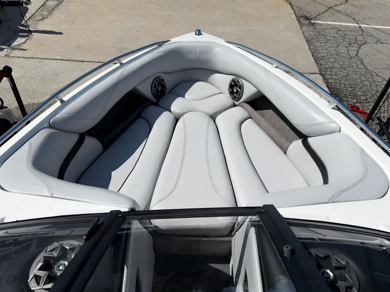 Slide: The Image of 2006 Malibu 23 VLX boat interior with white cushioned seating and speakers. - 4