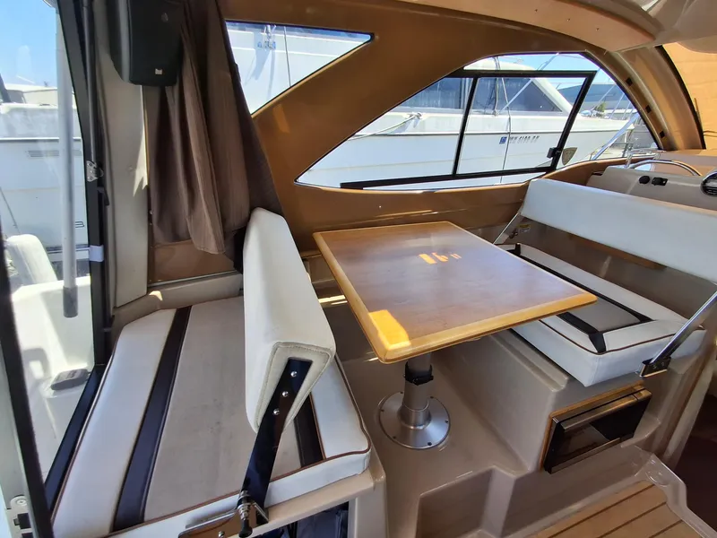 Slide: The Image of Interior of 2017 Cutwater C24 boat with seating and wooden table. - 11