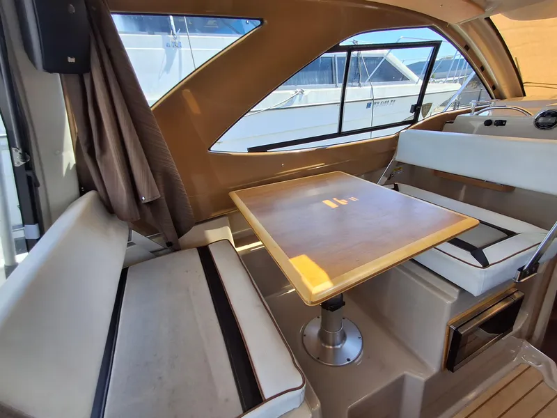 Slide: The Image of Interior of a 2017 Cutwater C24 boat with seating and a wooden table. - 14