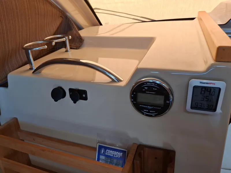 Slide: The Image of Interior dashboard of a 2017 Cutwater C24 boat with temperature display and controls. - 15