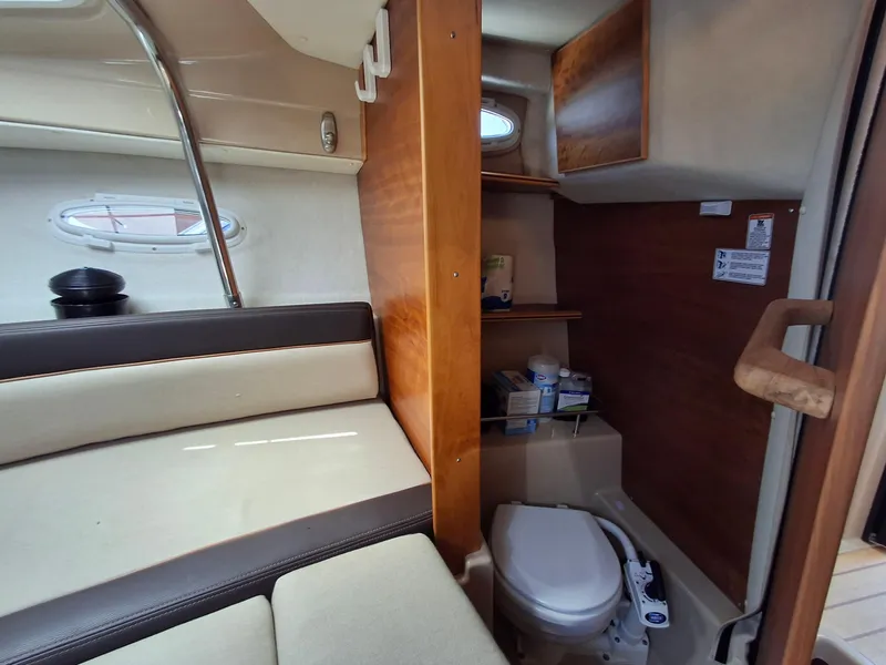 Slide: The Image of Interior of 2017 Cutwater C24 boat showing seating and compact bathroom area. - 19