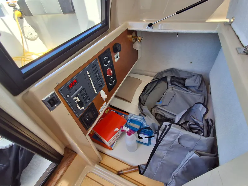 Slide: The Image of Interior of a 2017 Cutwater C24 boat showing storage and control panel. - 23