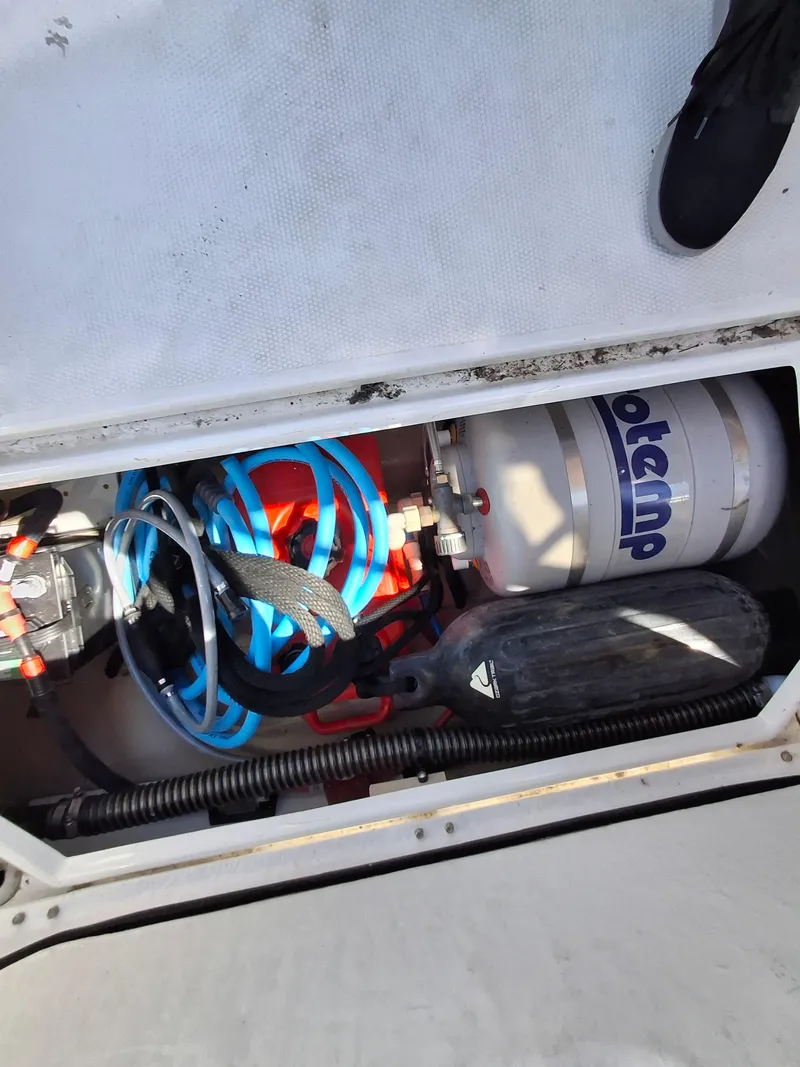 Slide: The Image of Storage compartment of a 2017 Cutwater C24 boat with equipment and hoses. - 32