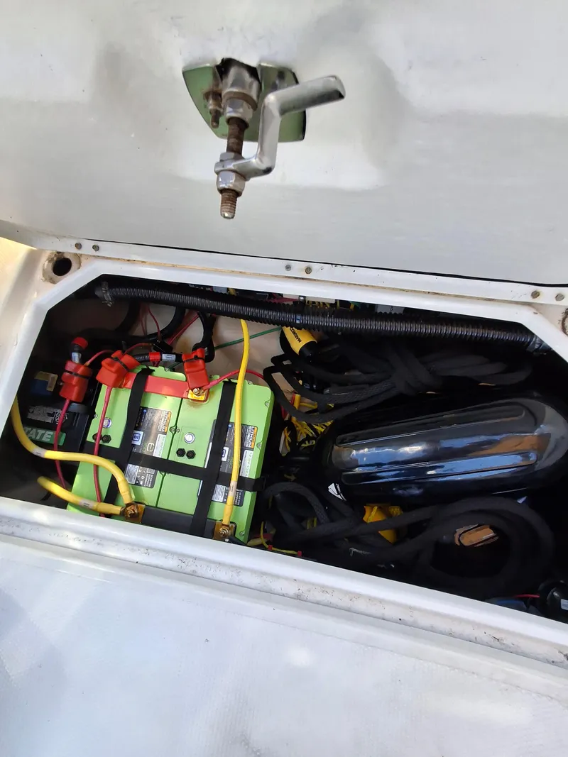 Slide: The Image of 2017 Cutwater C24 boat battery compartment with wiring and equipment. - 33