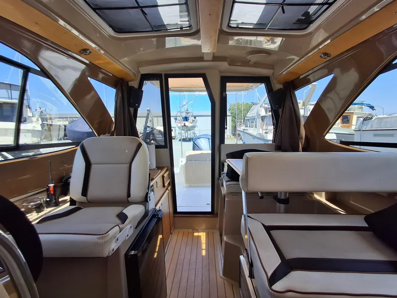 Slide: The Image of Interior of a 2017 Cutwater C24 boat with seating and windows. - 8