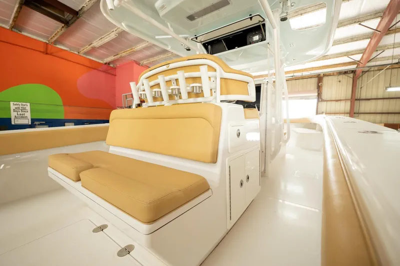 Slide: The Image of 2020 Bahama 41 Open Fisherman boat interior with tan seating in a warehouse. - 10