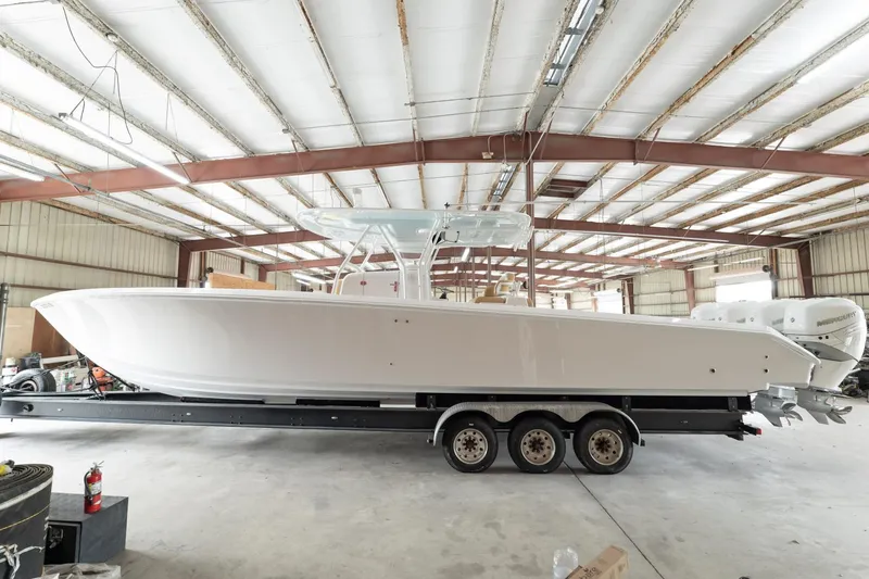Slide: The Image of 2020 Bahama 41 Open Fisherman boat on a trailer in a warehouse. - 12