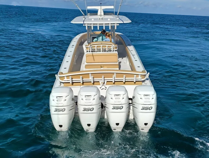 Slide: The Image of 2020 Bahama 41 Open Fisherman with quad 350 engines cruising on the ocean. - 2