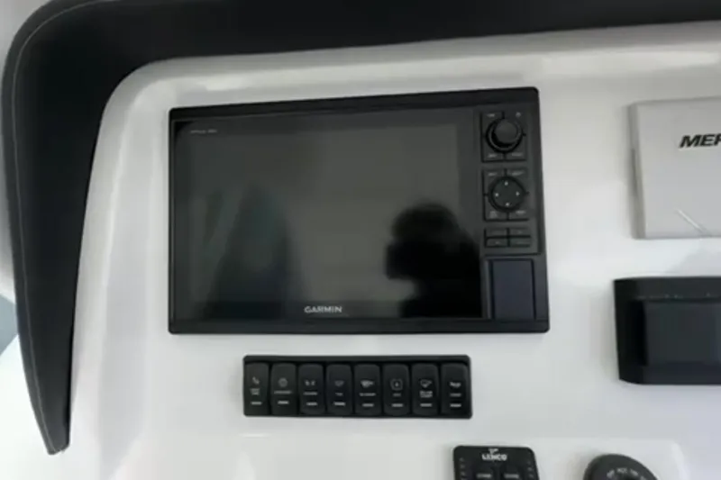 Slide: The Image of 2023 Airship 310-Rib boat interior, docked near buildings, showcasing sleek design and modern features. - 12