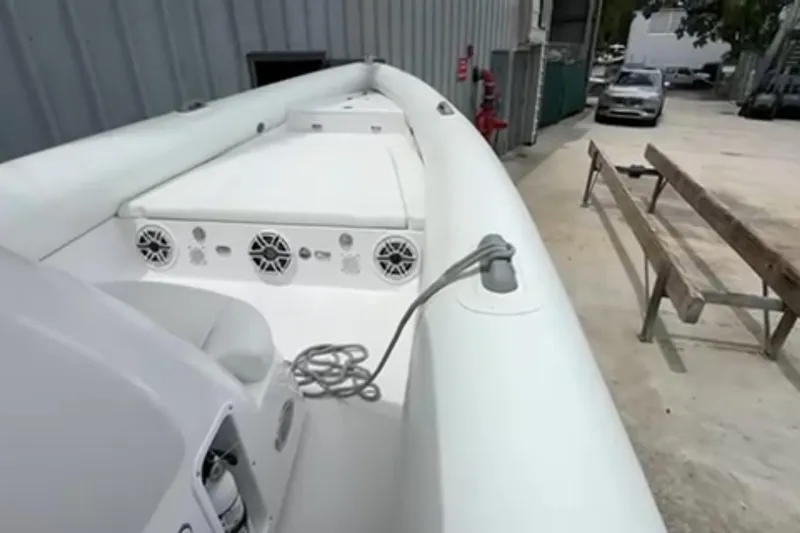 Slide: The Image of Interior view of 2023 Airship 310-Rib boat docked near urban waterfront. - 17