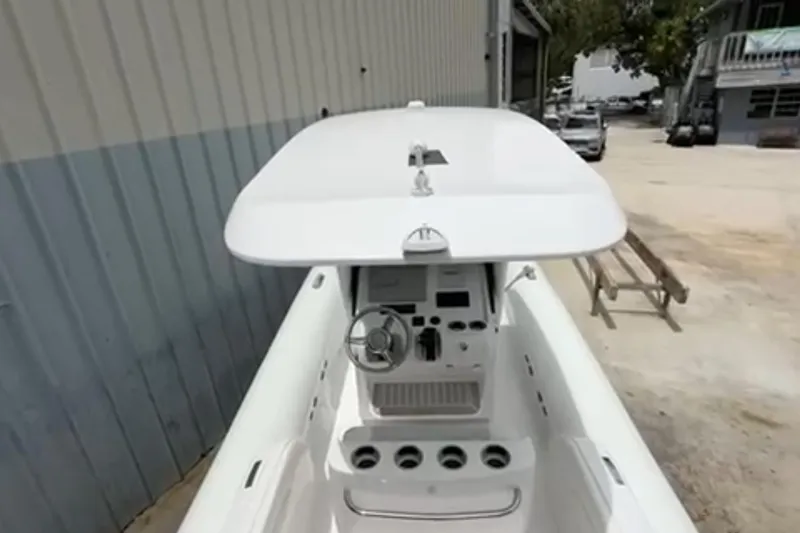 Slide: The Image of Airship 310-Rib boat docked near waterfront buildings and palm trees, 2023. - 19