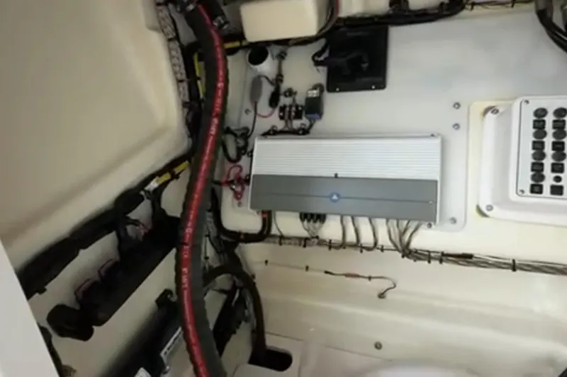 Slide: The Image of 2023 Airship 310-Rib boat with open storage compartment, dockside view. - 26