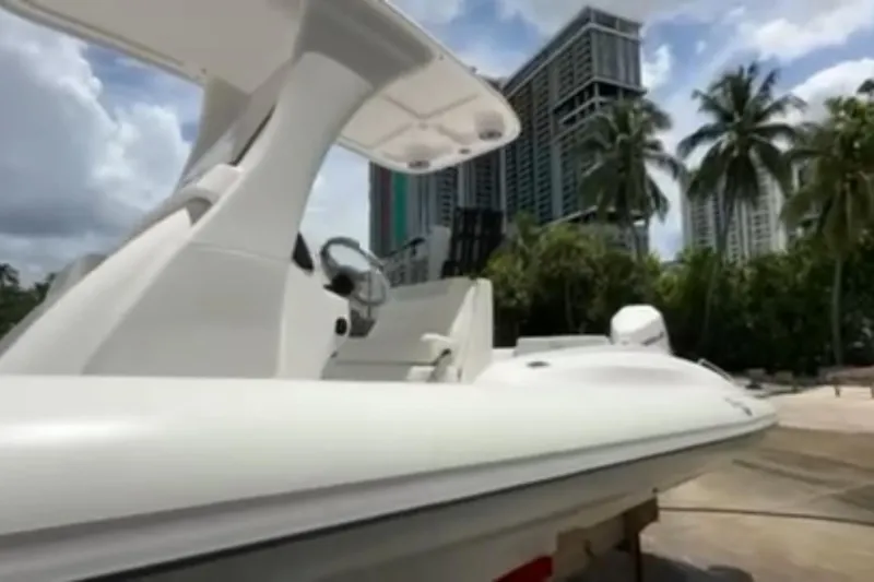 Slide: The Image of 2023 Airship 310-Rib boat on stands outside a building, urban background. - 4