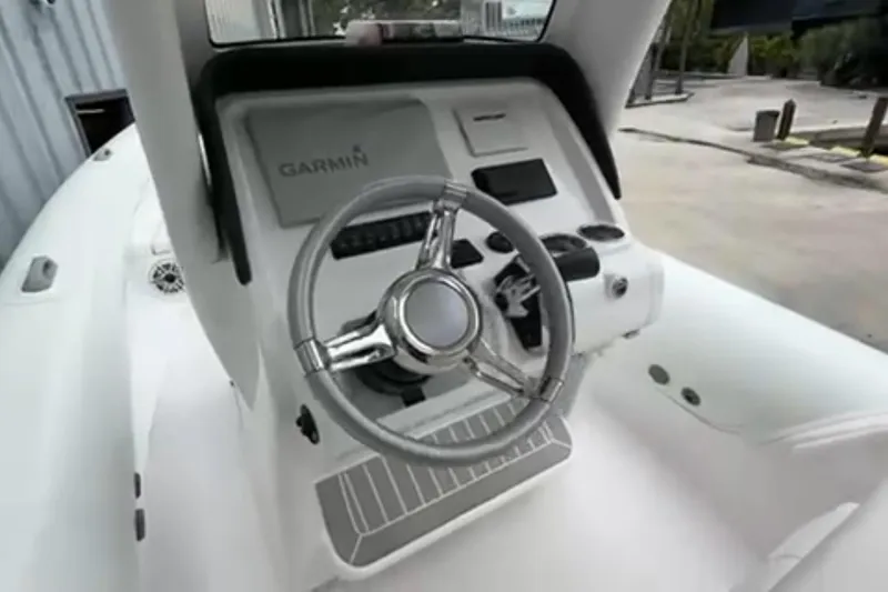 Slide: The Image of 2023 Airship 310-Rib boat on stand, showcasing engine and hull details. - 9