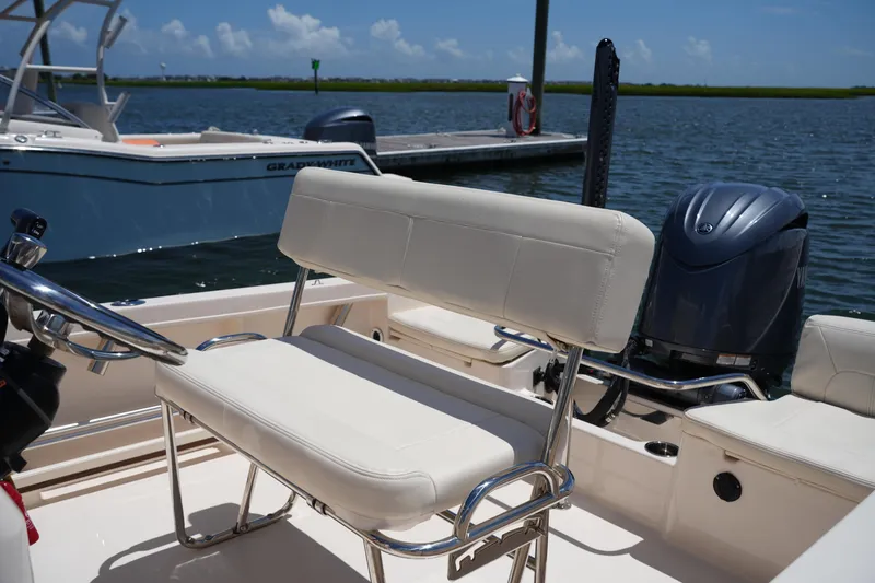 Slide: The Image of 2024 Grady-White Fisherman 180 boat interior with seating and outboard motor. - 14