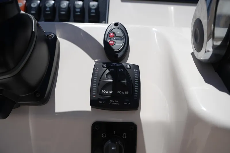 Slide: The Image of 2024 Grady-White Fisherman 180 boat control panel with trim tab and bow controls. - 17