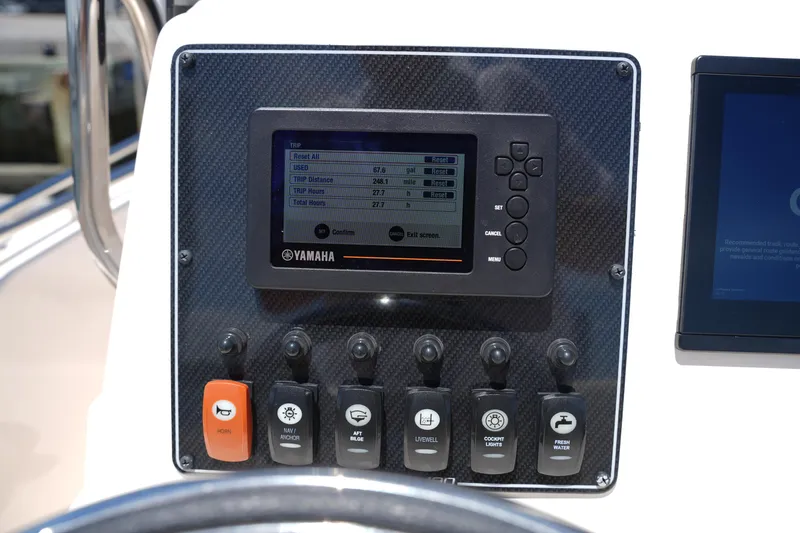 Slide: The Image of Control panel of 2024 Grady-White Fisherman 180 boat with Yamaha display and switches. - 18