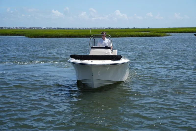 Slide: The Image of 2024 Grady-White Fisherman 180 boat cruising on a calm waterway. - 2