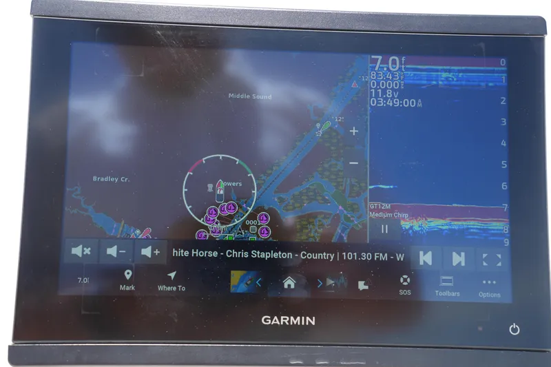 Slide: The Image of Garmin marine display showing navigation and music on Grady-White Fisherman 180, 2024 model. - 20