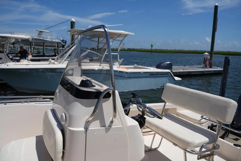 Slide: The Image of 2024 Grady-White Fisherman 180 boat docked, featuring sleek design and comfortable seating. - 22