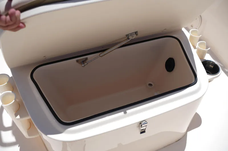 Slide: The Image of Open storage compartment on 2024 Grady-White Fisherman 180 boat, featuring cup holders. - 25