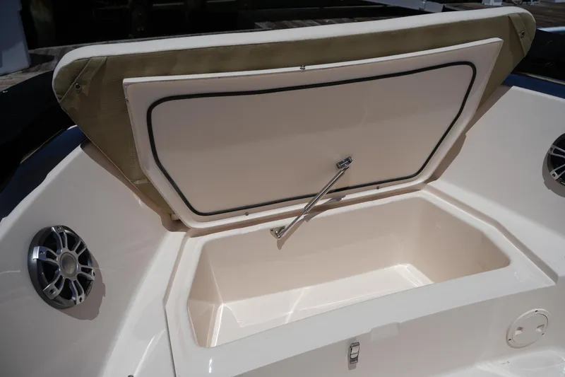 Slide: The Image of 2024 Grady-White Fisherman 180 boat storage compartment with open lid and speaker. - 27