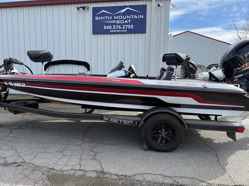 Slide: The Image of 2021 Skeeter ZX 150 boat on trailer at Smith Mountain Boat dealership. - 1