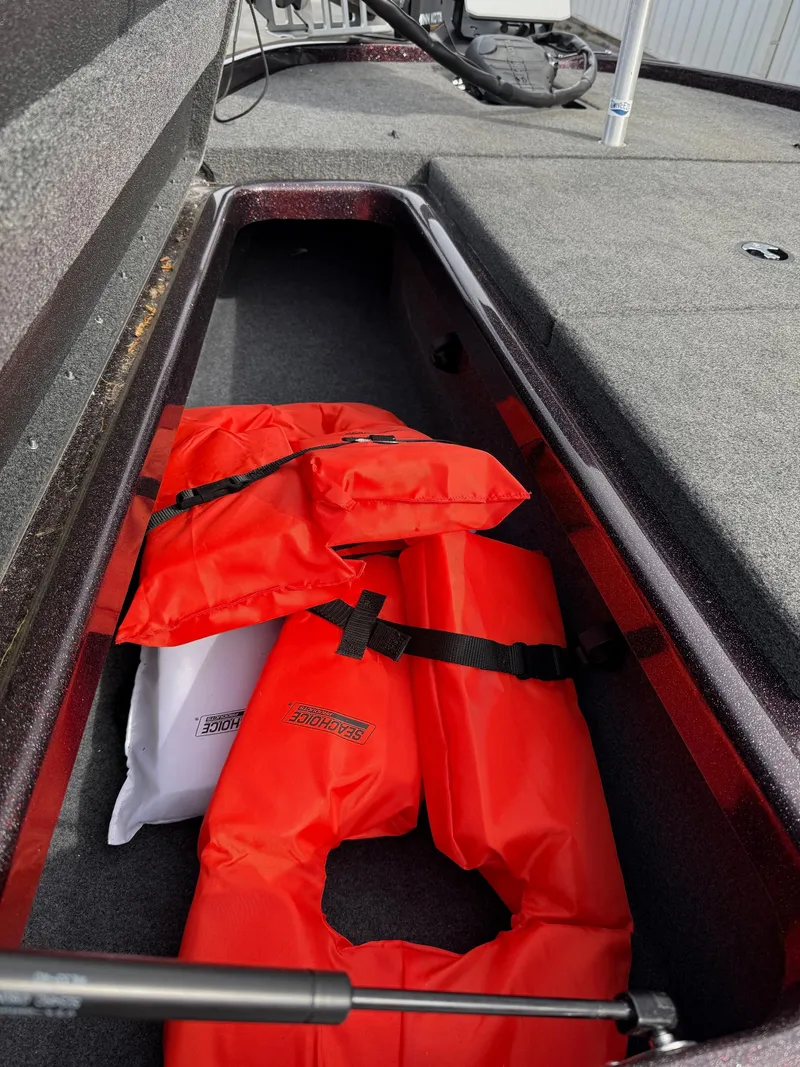 Slide: The Image of 2021 Skeeter ZX 150 boat storage with bright orange life jackets. - 10