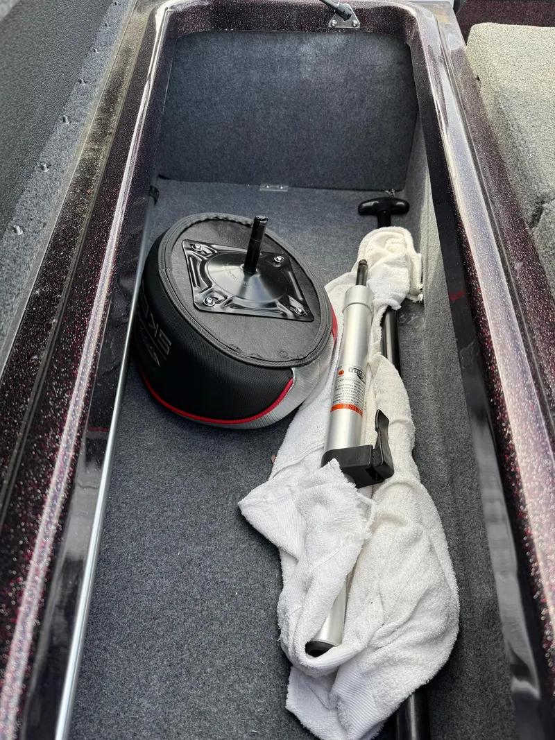 Slide: The Image of Storage compartment of 2021 Skeeter ZX 150 boat with pump and cover. - 11