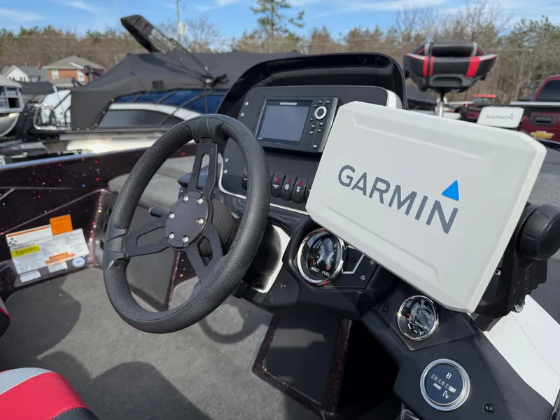 Slide: The Image of 2021 Skeeter ZX 150 boat dashboard with Garmin navigation system and steering wheel. - 7