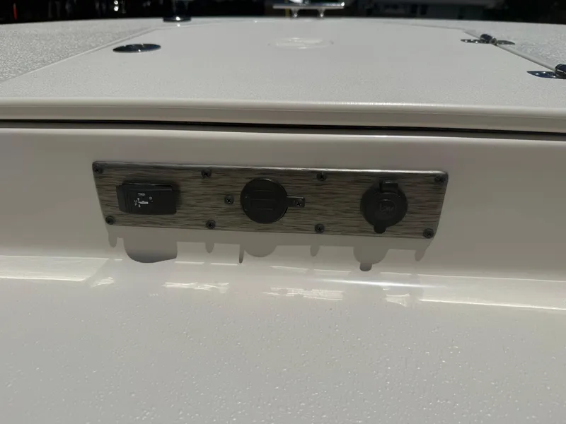 Slide: The Image of Control panel on 2025 Carolina Skiff 19 LS boat, featuring switches and outlets. - 12