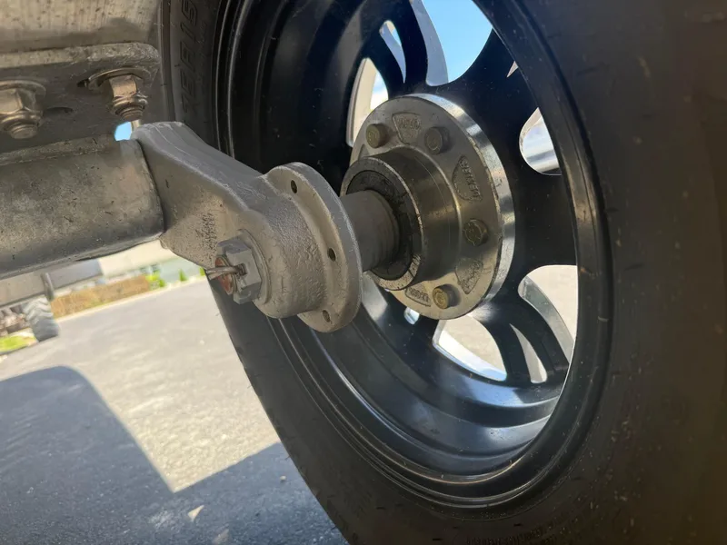 Slide: The Image of Close-up of a 2025 Carolina Skiff 19 LS trailer wheel and axle. - 16