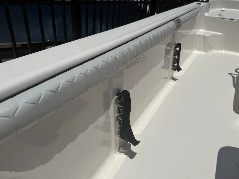 Slide: The Image of 2025 Carolina Skiff 19 LS boat interior with rod holders and cushioned side rail. - 7