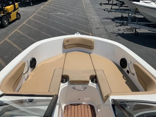 Slide: The Image of 2022 Bayliner VR4 Bowrider I/O boat interior with tan seating and speakers. - 10