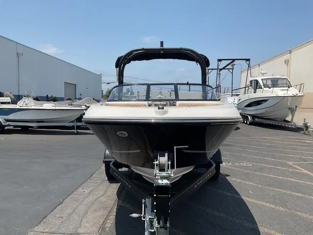 Slide: The Image of 2022 Bayliner VR4 Bowrider I/O on trailer in marina parking lot. - 2