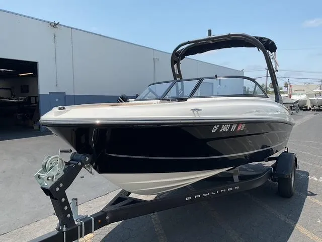Slide: The Image of 2022 Bayliner VR4 Bowrider I/O on trailer, parked outside a warehouse. - 3