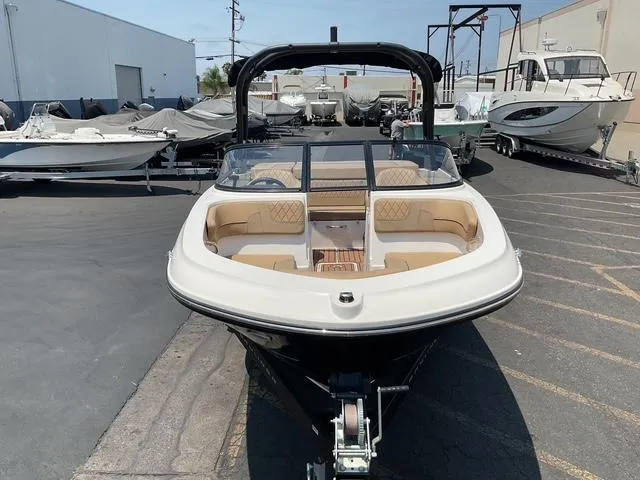 Slide: The Image of 2022 Bayliner VR4 Bowrider I/O in a boatyard, showcasing sleek design and spacious seating. - 8